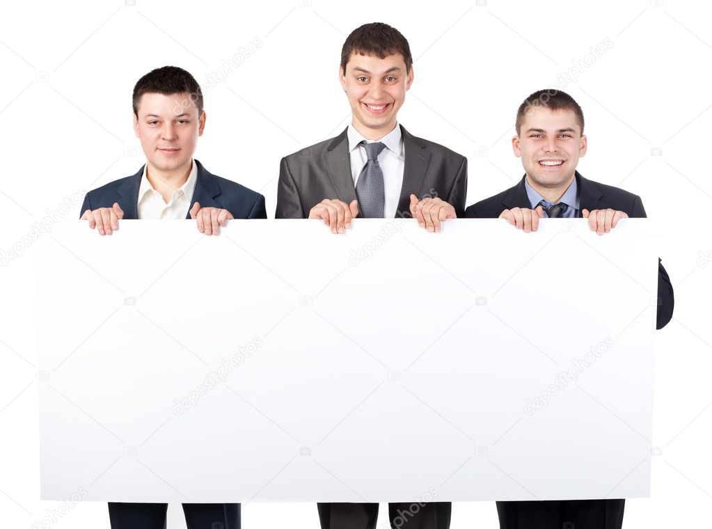 Three young businessmen hold up a large blank sign isolated on w