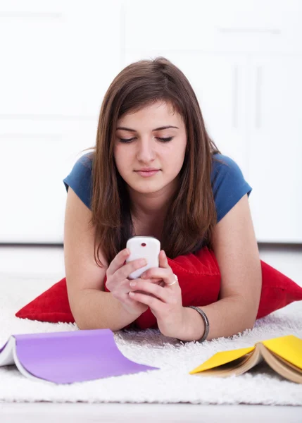 Teenager texting instead of learning — Stock Photo, Image
