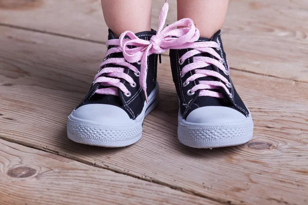 Partial success - child tied two shoes together — Stock Photo, Image