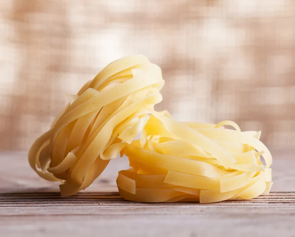 Pasta on old wooden table - closeup — Stock Photo, Image