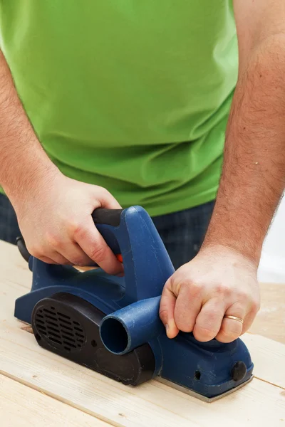 Male worker hands with electric planer — Stock Photo, Image
