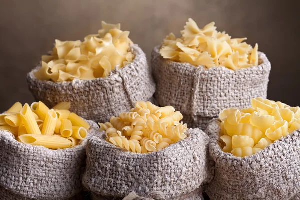 Pasta assortment in burlap bags — Stock Photo, Image