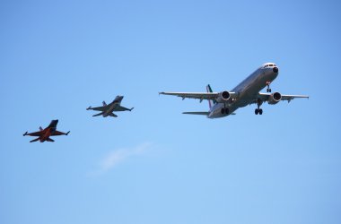 Airbus A320 aircraft accompanied by two fighters F16 clipart