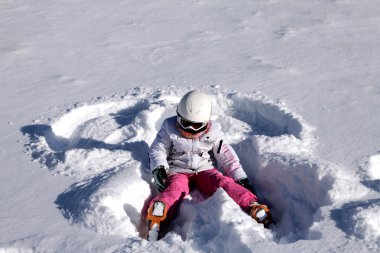 Girl lies on snow. Snow angel clipart