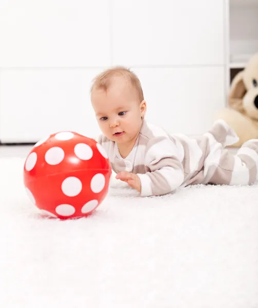 Baby girl with red ball — Stock Photo, Image