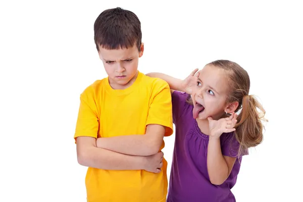 Young girl teasing and mocking a boy — Stock Photo, Image