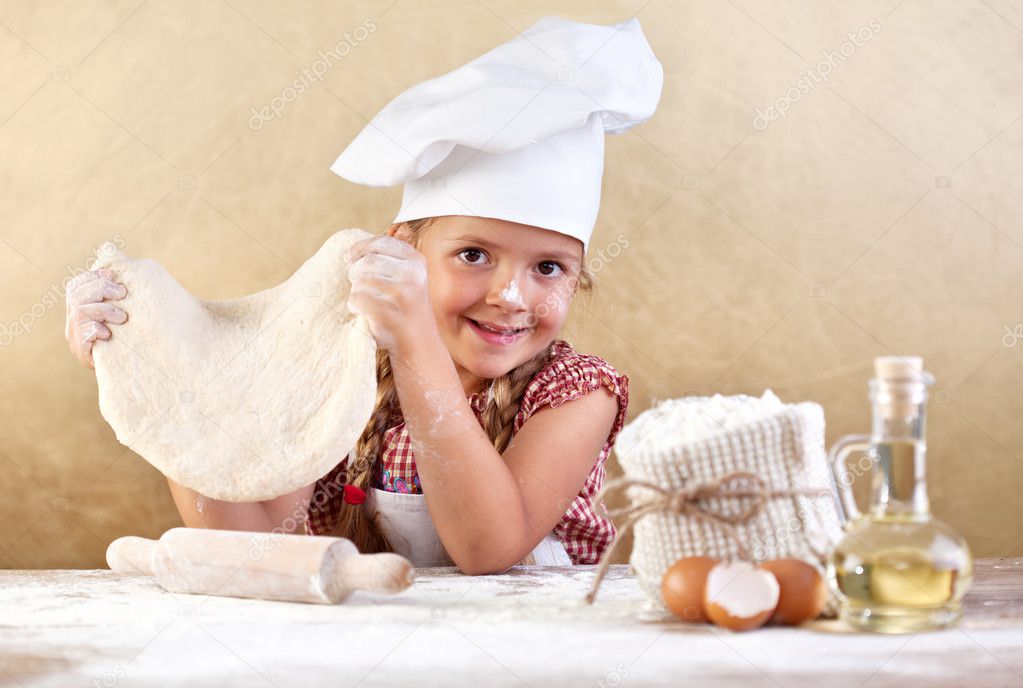 Little girl making pizza or pasta dough
