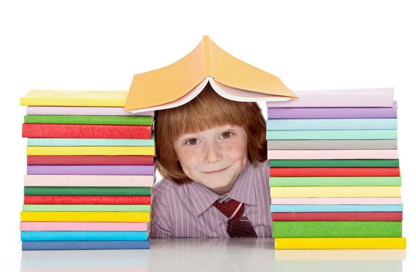 Niño de escuela pequeña con camisa y corbata y muchos libros — Foto de Stock