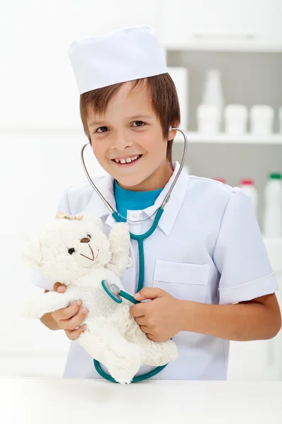 Liten pojke spela veterinärmedicinska läkare Stockbild