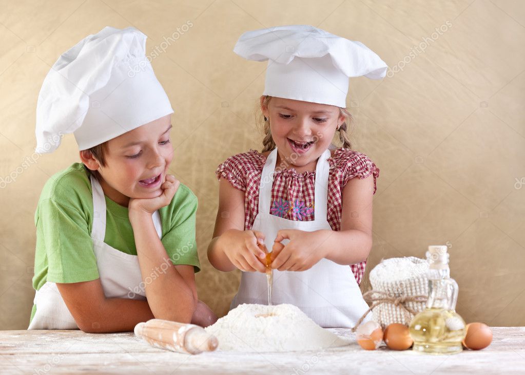 Kids preparing the dough for a cookie, pizza or pasta