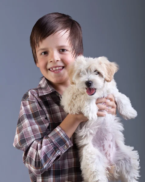 Happy boy holding his fluffy dog — Stock Photo, Image