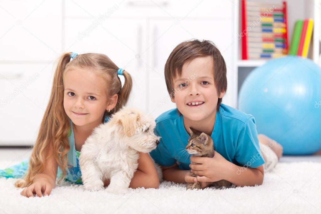 Happy kids with their pets - a dog and a kitten