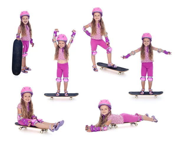 Klein meisje in roze met skateboard — Stockfoto