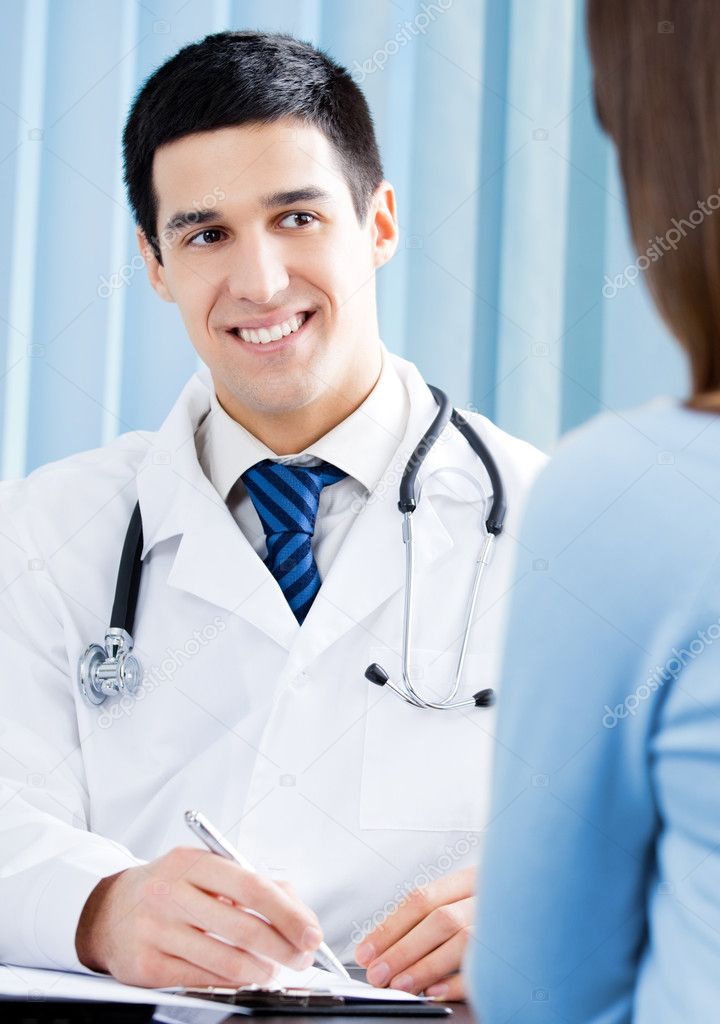 Smiling doctor and female patient at office