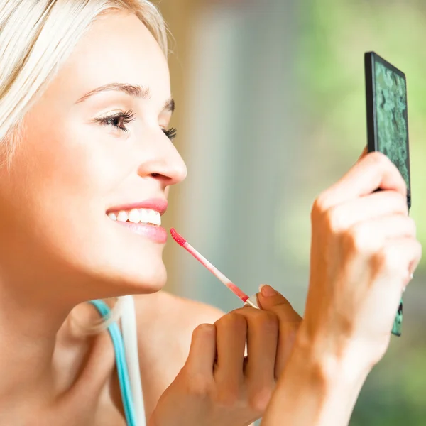 Feliz hermosa mujer aplicando lápiz labial — Foto de Stock