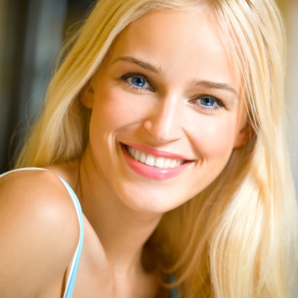 Lächelnde junge schöne Frau, drinnen — Stockfoto
