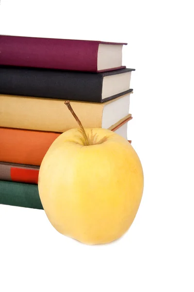 Yellow apple with books on white background — Stock Photo, Image