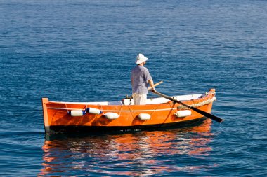 Sailor rowing on wooden taxi boat clipart