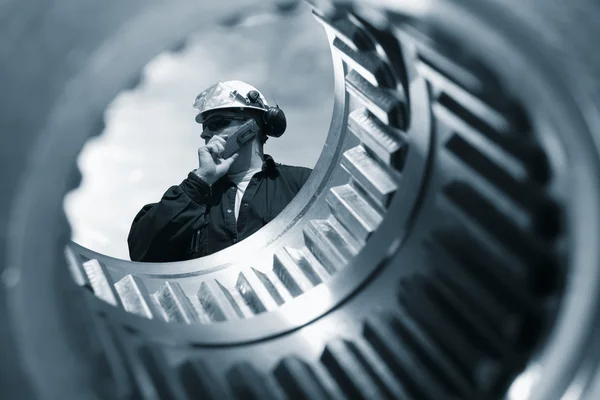 Engineer and giant gears — Stock Photo, Image