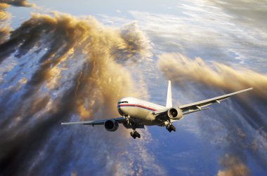 Airliner flying over dramatic clouds clipart