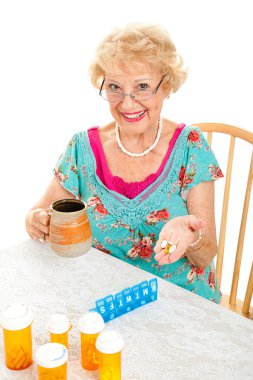 Smiling Senior Woman Takes Medicine clipart