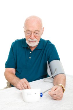 Senior Man Takes His Blood Pressure clipart