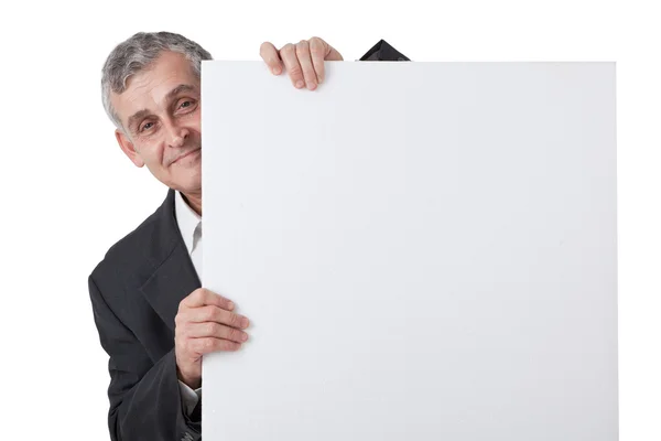 Empresario sosteniendo un cartel en blanco frente a él — Foto de Stock