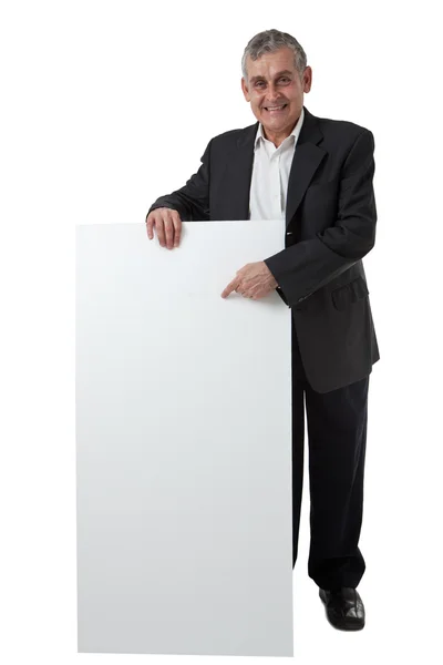 Empresario sosteniendo un cartel en blanco frente a él — Foto de Stock