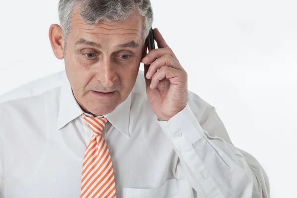 Портрет пожилого бизнесмена, звонящего с мобильного телефона — стоковое фото