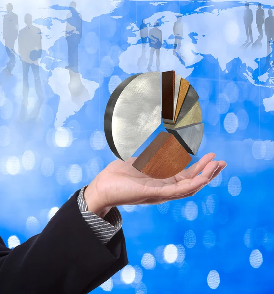 Business man holding pie graph with world map background — Stock Photo, Image
