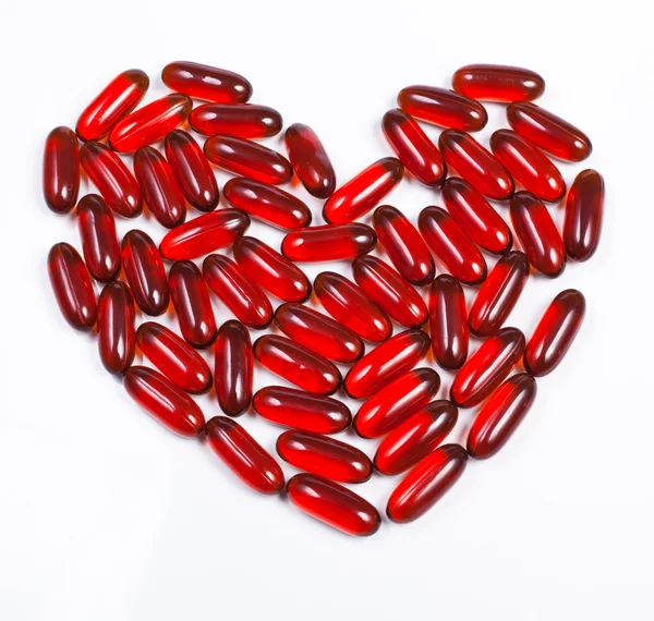 Corazón hecho de cápsula roja — Foto de Stock