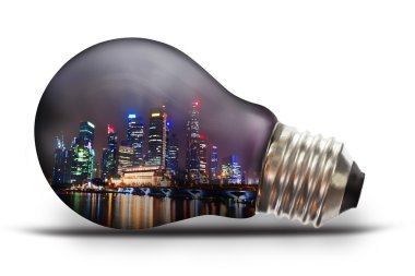 Light bulb with city scape at night clipart