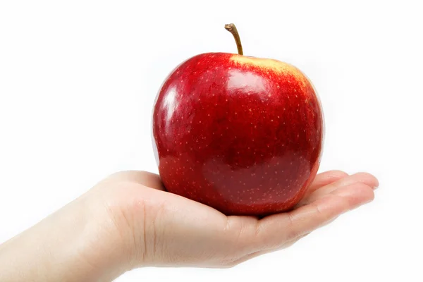 Kadın eli beyaz zemin üzerine izole bir elma — Stok fotoğraf