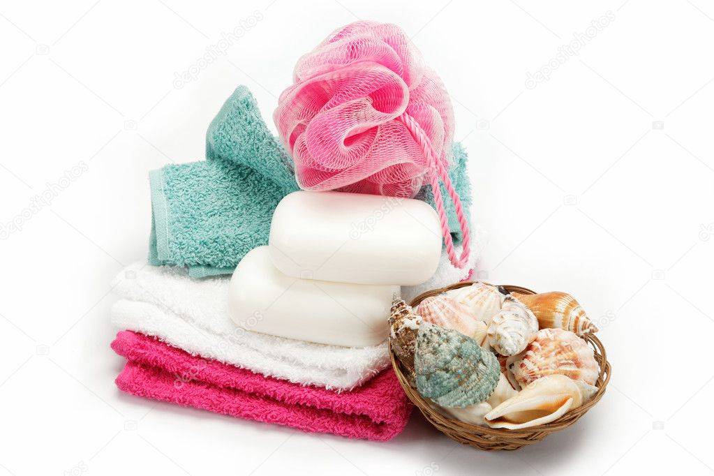Spa or bathroom concept with towels and soaps, on a white backgr