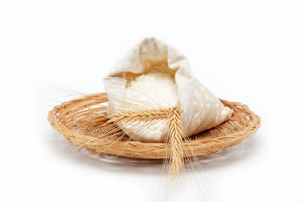 Mehl und Weizenkorn auf einem Weidenkorb. — Stockfoto