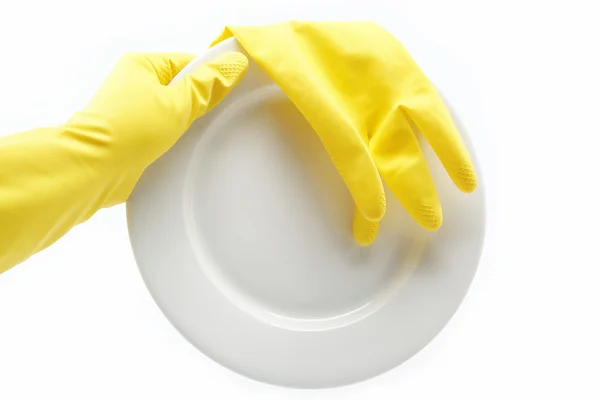 Hand in rubber glove with a plate on a white background. — Stock Photo, Image