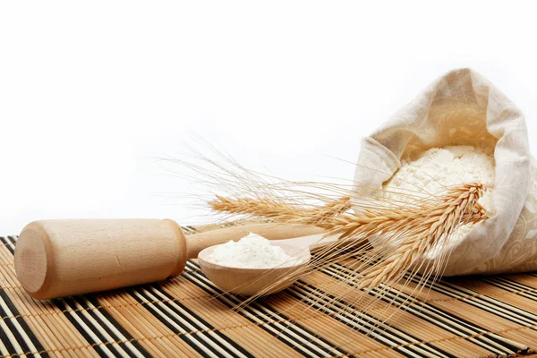Flour and wheat grain with wooden spoon on a wooden table. — Stock Photo, Image