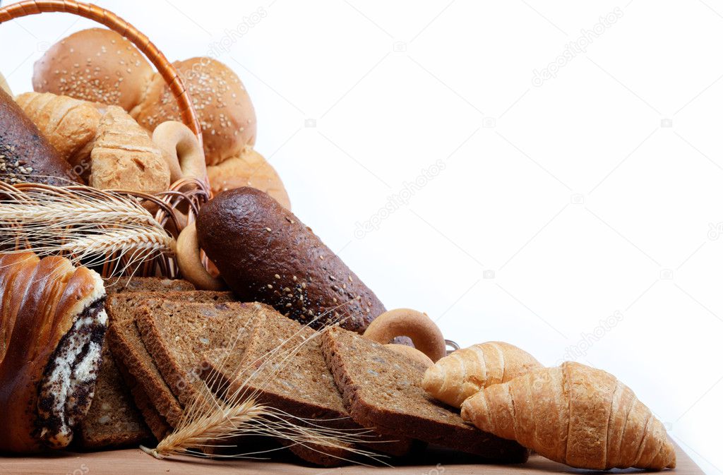 Large variety of bread, still life isolate on a wooden table ove