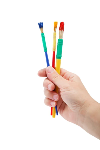 Mano femminile che tiene pennelli colorati per disegnare, isolato sopra — Foto Stock