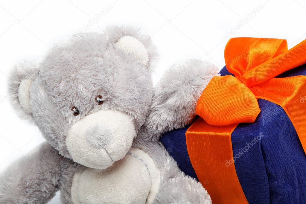 Gift pack and teddy bear on a white background.