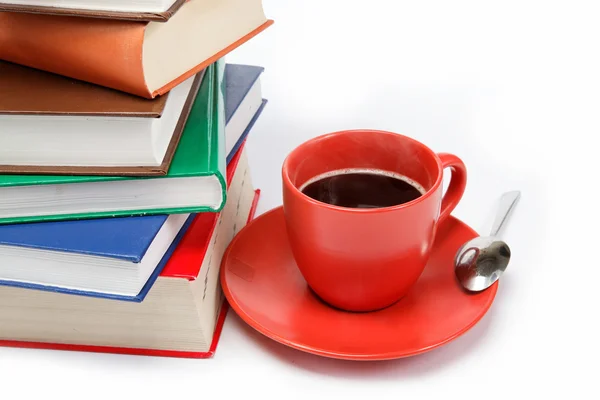 stock image A stack of books and a cup of coffee in a saucer on a white back