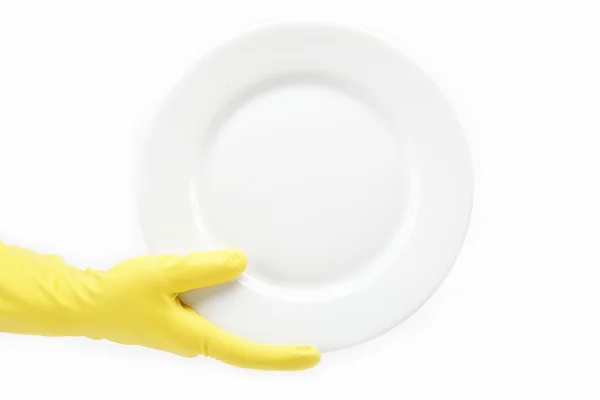 Hand in Gummihandschuh mit einem Teller auf weißem Hintergrund. — Stockfoto