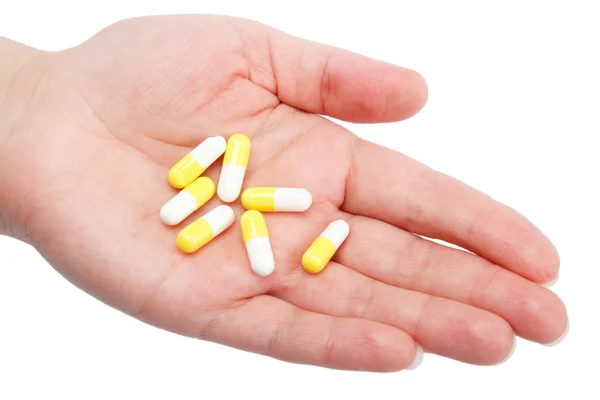 Tabletki w ręce kobieta na białym tle — Zdjęcie stockowe