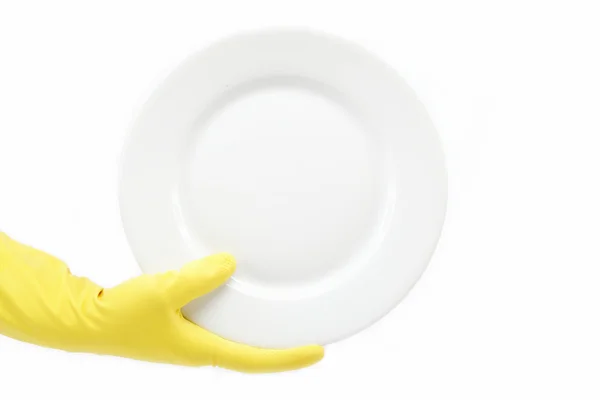 Hand in Gummihandschuh mit einem Teller auf weißem Hintergrund. — Stockfoto