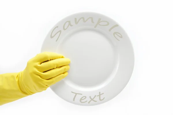 Χέρι-καουτσούκ γάντι με ένα πιάτο σε λευκό φόντο. — Φωτογραφία Αρχείου