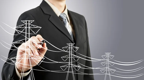 Hombre de negocios dibujo pilón eléctrico y alambre —  Fotos de Stock