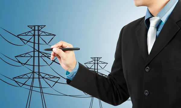 Hombre de negocios dibujo pilón eléctrico y alambre —  Fotos de Stock