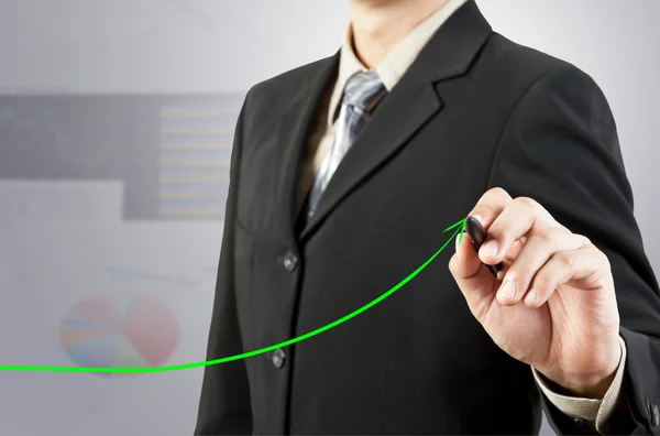 ビジネスマン手描きのグラフが緑の矢印 ロイヤリティフリーのストック写真