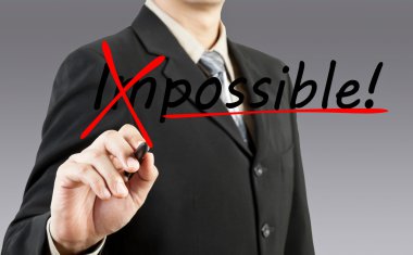 Motivation concept. Businessman changing the word impossible int clipart