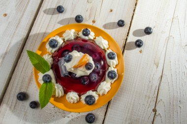 Fruit dessert with cream served on a plate clipart